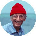 old person with a red hat smiling to camera